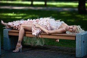 Sexy bride laying down on bench showing legs